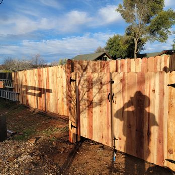 New redwood privacy fence with a custom double gate